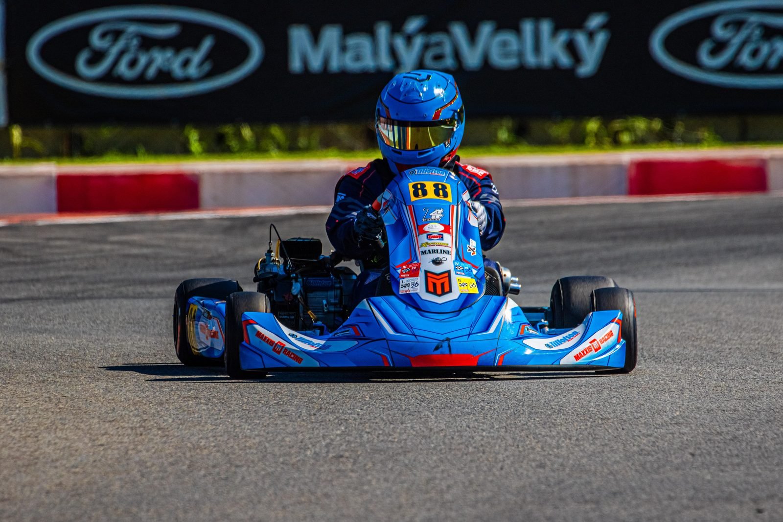 Samuel Uváček, karting driver, in his blue number 88 kart turning into a corner