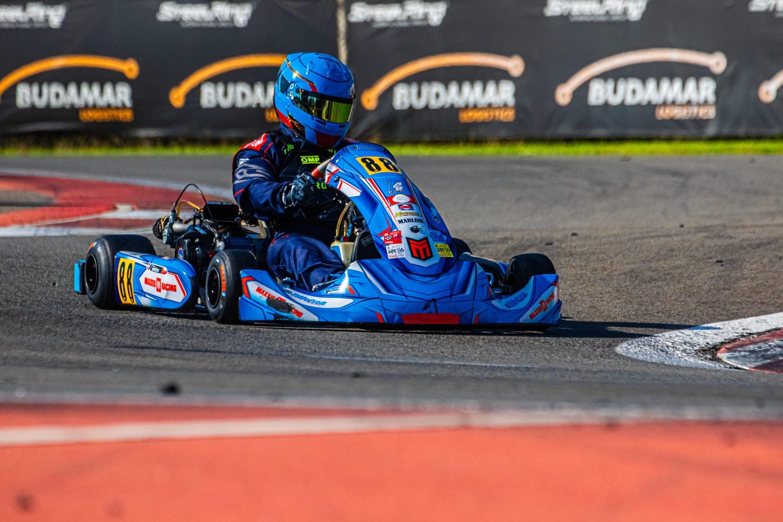 Samuel Uváček in kart number 88 exiting a corner