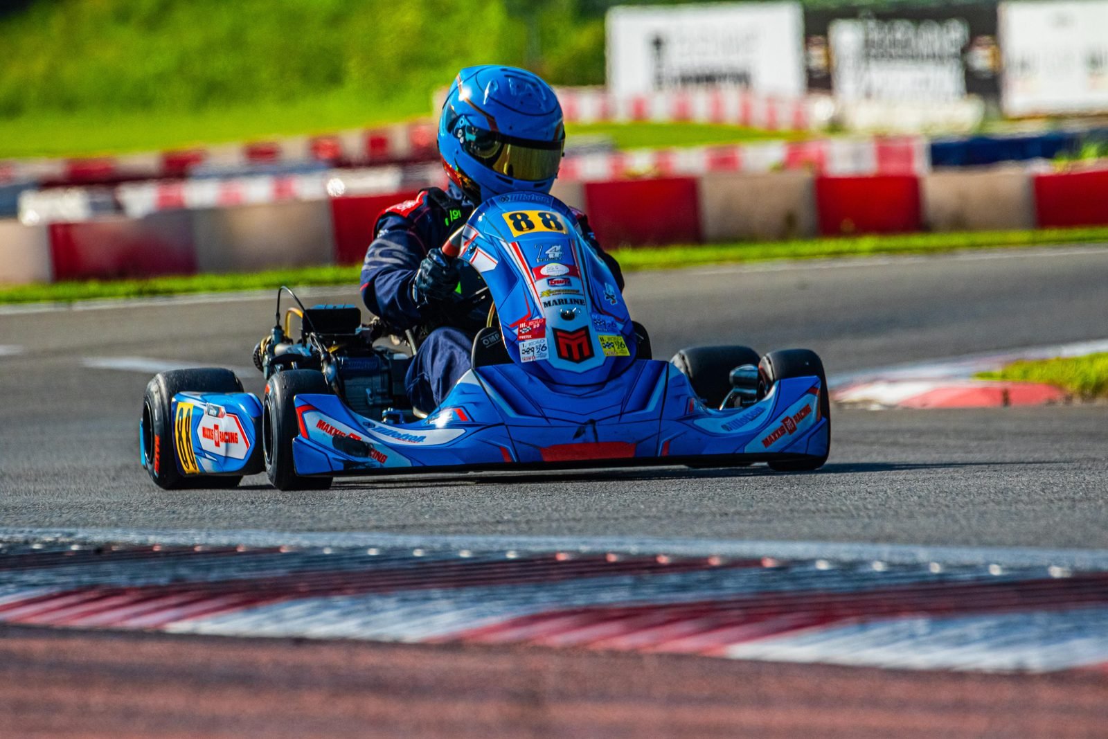 Samuel Uváček in kart number 88 cornering over the kerb